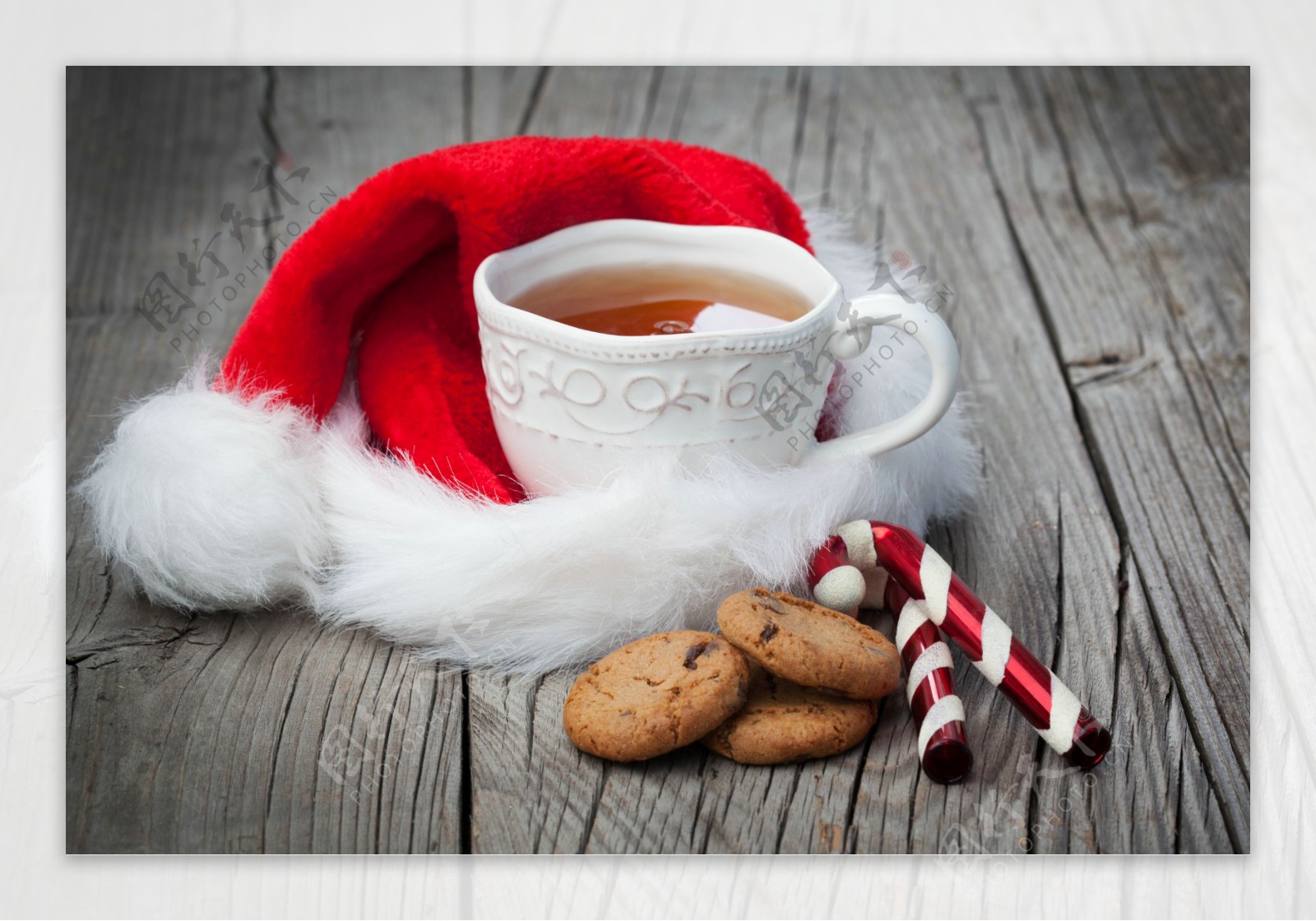 圣诞帽上的茶与木板上的饼干图片