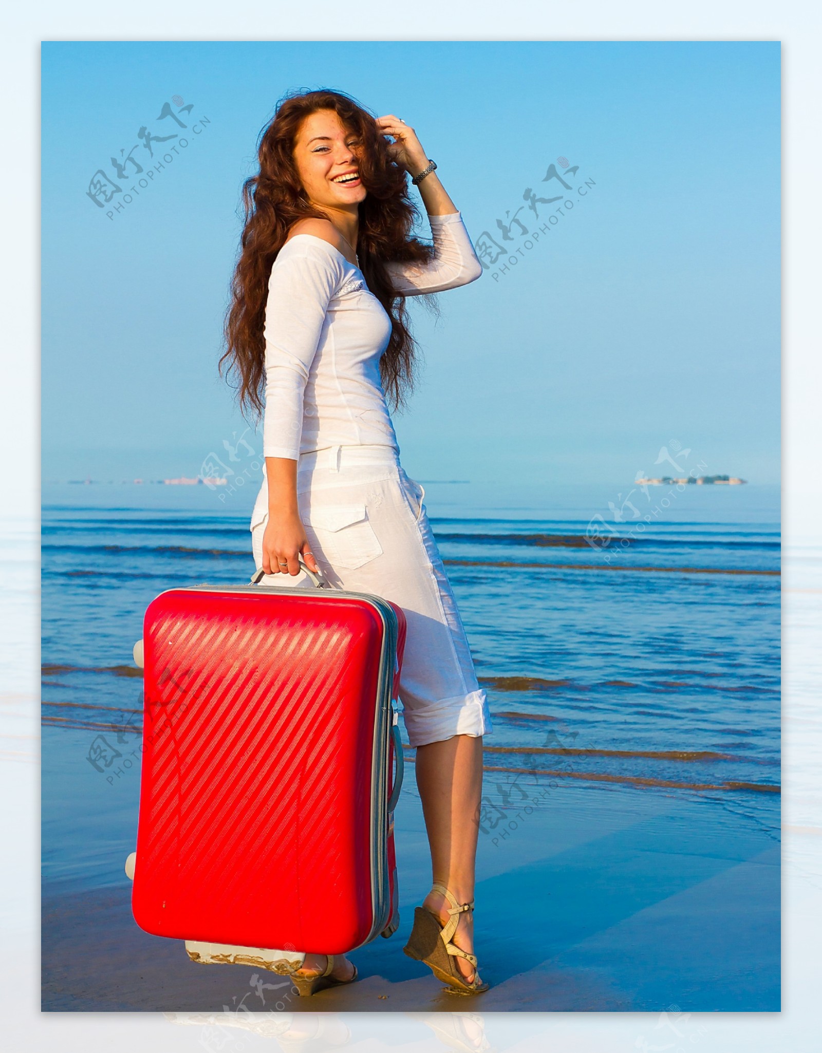 海边提着行李箱的女人图片